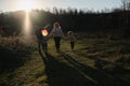 Have fun spending time with two children outdoors in nature. Young Caucasian parents with their son and daughter run across field Royalty Free Stock Photo