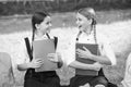 Have funny dialogue. back to school. teen pupils ready for lesson. prepare to exam. study together outdoor. small girls Royalty Free Stock Photo