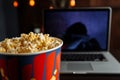 Have a good evening watching a movie on a laptop with popcorn Royalty Free Stock Photo