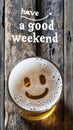 Have a good weekend sign next to a Beer Glass with a Happy Face with a Smile on the Foam