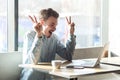 Have idea! Portrait of creative positive bearded young freelancer in blue shirt are sitting in cafe and working on laptop with