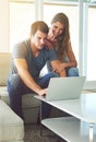 Have a look at this. a young couple using a laptop at home. Royalty Free Stock Photo