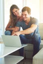 Have a look at this. a young couple using a laptop at home. Royalty Free Stock Photo