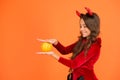 Have magic Halloween. Little demon child cast magic spell upon pumpkin. Pumpkin is magic vegetable. Charm or magic Royalty Free Stock Photo