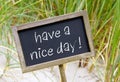 Have a nice day - chalkboard with text at the beach Royalty Free Stock Photo