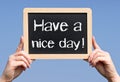 Have a nice day - female hands holding chalkboard with text Royalty Free Stock Photo