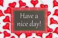 Have a nice day greeting on hanging sign with red hearts on white fabric Royalty Free Stock Photo