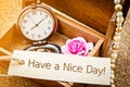 Have a nice day on paper tag with vintage pocket watch. Royalty Free Stock Photo