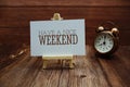 Have a nice weekend text on paper card on wooden background Royalty Free Stock Photo