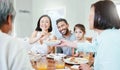 We have our differences, but nothings more important than family. a young couple have some lunch with the family at home Royalty Free Stock Photo