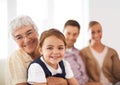 They have a special bond. Portrait of a grandmother hugging her granddaughter with her parents in the background. Royalty Free Stock Photo