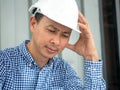 Have stress, Asia Engineer serious thinking, young man and looking away while sitting Royalty Free Stock Photo