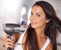 Have you tried this new hairdryer. a beautiful young woman blow drying her hair. Royalty Free Stock Photo