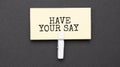 HAVE YOUR SAY text on paper with wihte clip. On black background Royalty Free Stock Photo