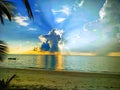 Havelock Island beach with boat, clouds and sun-rays
