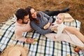 Haves picnic. Happy family of mother, family and little baby rests outdoors. Beautiful sunny autumn nature