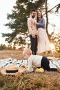 Haves picnic. Happy family of mother, family and little baby rests outdoors. Beautiful sunny autumn nature