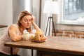 Woman feeling hungry looking at bread and buns but having allergy