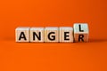 Having anger or being an angel. Turned a wooden cube and changed the word anger to angel. Beautiful orange background. Business Royalty Free Stock Photo