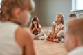 Having a break. A group of little cute girls sitting on the floor in the dance school. Choreography class. Little Royalty Free Stock Photo