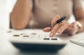 Having a budget keeps your spending and saving in check. Closeup shot of an unrecognisable businesswoman calculating