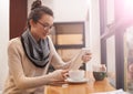 Having a coffee date with her techno friend. A young woman using her digital tablet in a coffee shop. Royalty Free Stock Photo