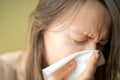 Having a cold or corona virus flu symptoms. Young woman with a an allergy sneezing into her handkerchief. Royalty Free Stock Photo