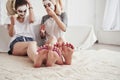 Having conversation. Pedicure and painted leg nails. Conception of skin care by using white mask and cucumbers on the Royalty Free Stock Photo