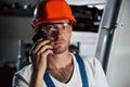 Having conversation. Portrait of engineer in metallurgical factory in protective helmet and eyewear