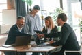 Having conversation, talking about plan. Group of business people are working in the modern office Royalty Free Stock Photo