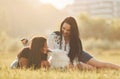 Having conversation. Two women with dog is having fun on the field at sunny daytime Royalty Free Stock Photo