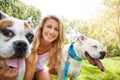 Having a dog brings many upsides to my life. a young woman with her two dogs at the park. Royalty Free Stock Photo