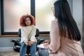 Curly woman having emotional disorder listening to psychoanalyst