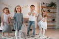 Having fun at birthday party. Group of children is together at home at daytime Royalty Free Stock Photo