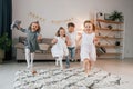 Having fun at birthday party. Group of children is together at home at daytime Royalty Free Stock Photo