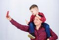 Having fun. Fathers day. Father example of noble human. Father little son red shirts family look outfit. Taking selfie Royalty Free Stock Photo