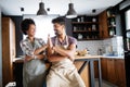 Beautiful young couple cooking healthy food together at home. Having fun in the kitchen. Royalty Free Stock Photo