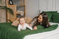 Having fun with mom and baby on the bed at home Royalty Free Stock Photo