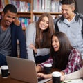 Having fun with their group project. a group of university students doing a group project in the campus library. Royalty Free Stock Photo