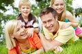 Having fun together as a family. Happy young family lying together on the grass at home. Royalty Free Stock Photo