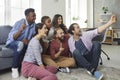 Multiracial group of happy young friends taking a selfie on a modern mobile phone Royalty Free Stock Photo