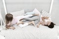 Having fun together. fun before sleep. best friends. sisters playing in bed. sweet dreams. pajama party in bedroom Royalty Free Stock Photo