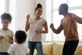 Happy laughing black family of four dancing at home Royalty Free Stock Photo