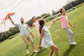 Having fun together. Happy and young family of four launcinging a kite in the field. Royalty Free Stock Photo