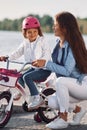 Having fun together. Mother with her young daughter is with bicycle outdoors together Royalty Free Stock Photo