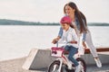 Having fun together. Mother with her young daughter is with bicycle outdoors together Royalty Free Stock Photo