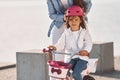 Having fun together. Mother with her young daughter is with bicycle outdoors together Royalty Free Stock Photo