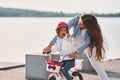 Having fun together. Mother with her young daughter is with bicycle outdoors together Royalty Free Stock Photo