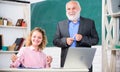 Having fun together. student and tutor with laptop. happy student girl with tutor man at blackboard. pass exam. teachers Royalty Free Stock Photo