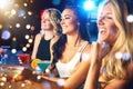 Having a girls night out. young women partying in a nightclub. Royalty Free Stock Photo
